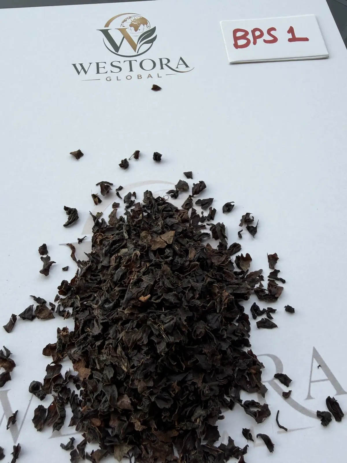 Dry Assam orthodox black tea, BPS1 grade, on a Westora Global sample sheet